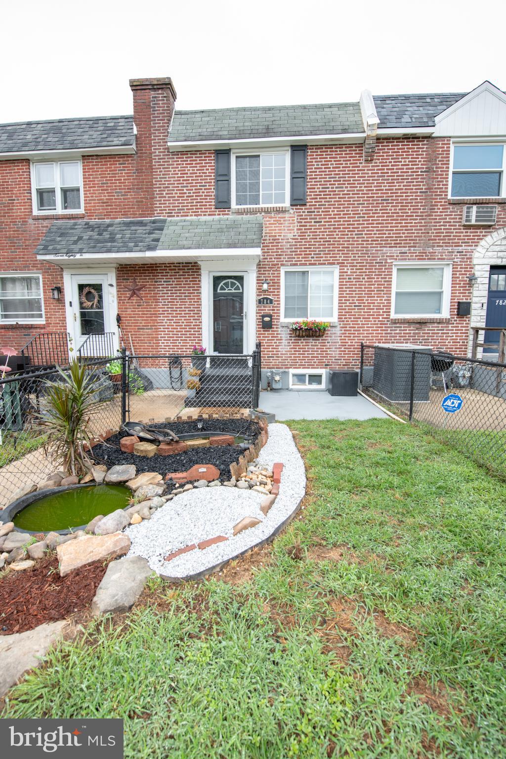 a front view of a house with a garden and patio