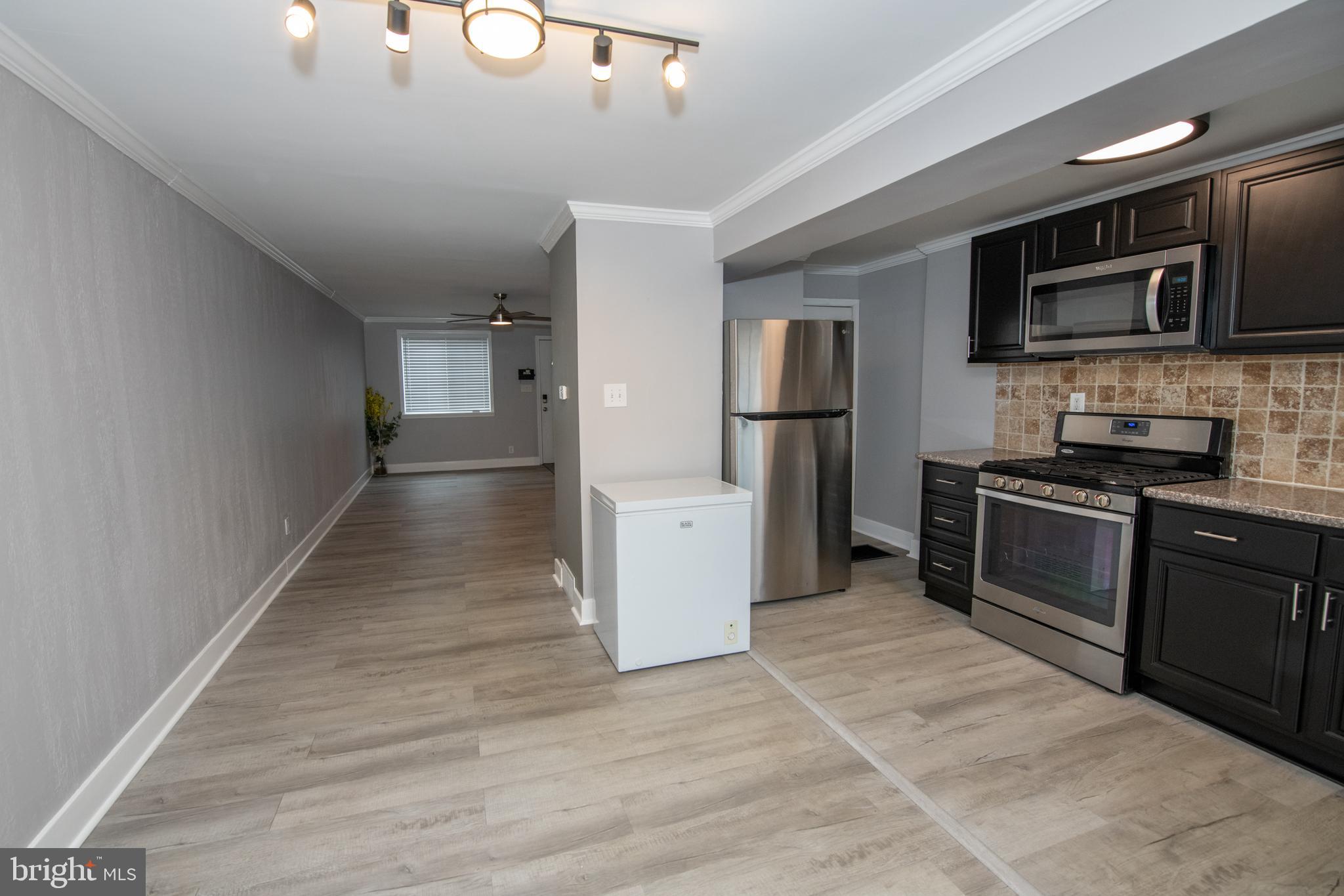 784 Bennington Road Folcroft, PA 19032 - Photo 15 of 36 a kitchen with stainless steel appliances granite countertop a refrigerator and a stove top oven