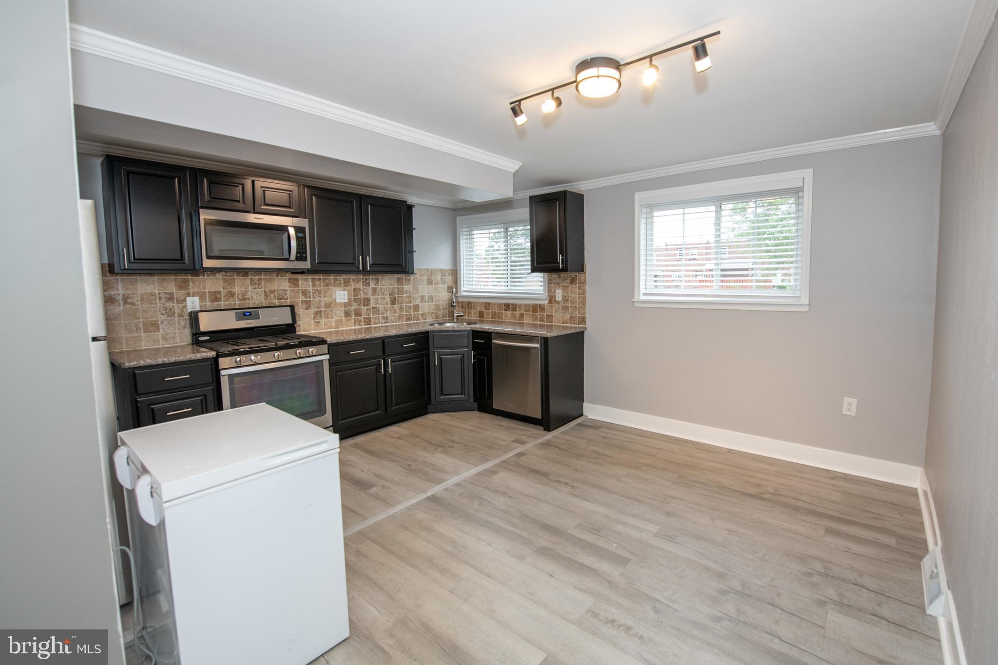 784 Bennington Road Folcroft, PA 19032 - Photo 16 of 36 a kitchen with stainless steel appliances kitchen island a cabinets and wooden floor