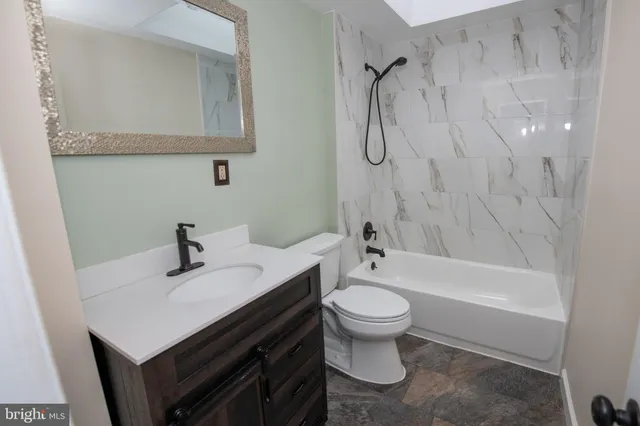 a bathroom with a sink a toilet and a bathtub