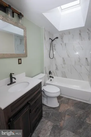 a bathroom with a sink a toilet and a bathtub