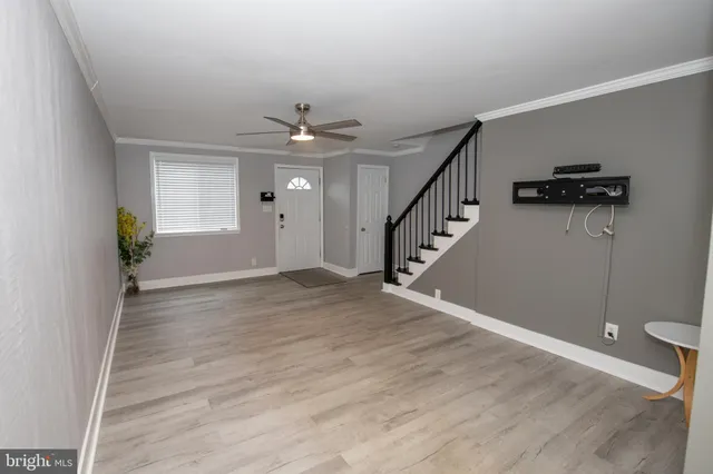 a view of an entryway with wooden floor