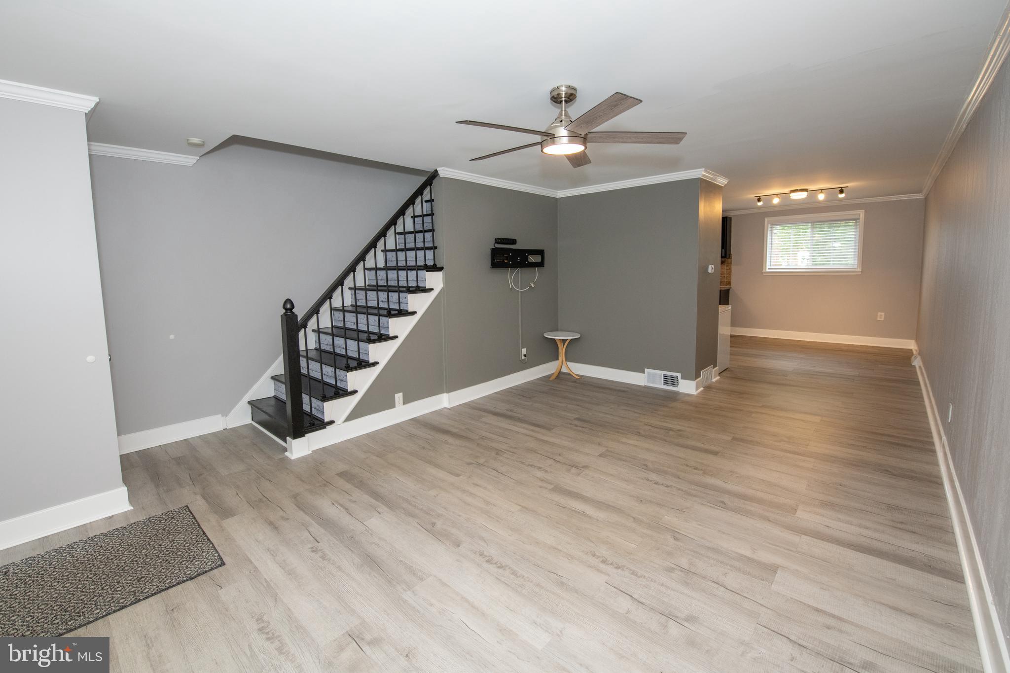 784 Bennington Road Folcroft, PA 19032 - Photo 5 of 36 an empty room with wooden floor fan and windows