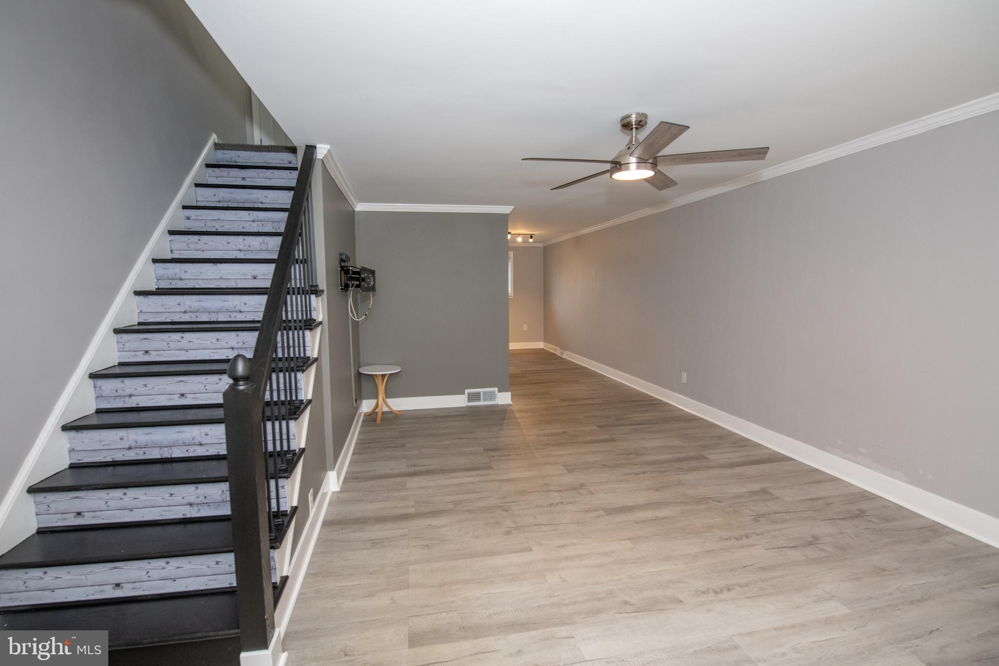 784 Bennington Road Folcroft, PA 19032 - Photo 6 of 36 wooden floor in an empty room with a staircase