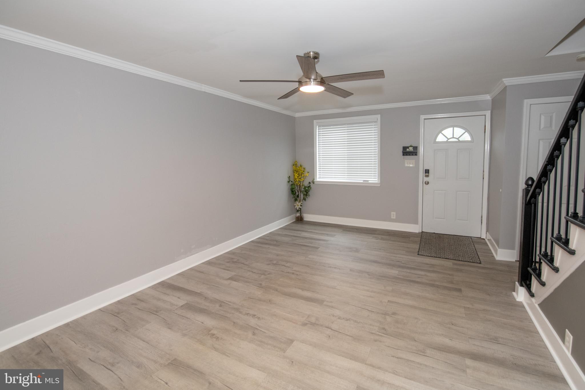 784 Bennington Road Folcroft, PA 19032 - Photo 7 of 36 an empty room with wooden floor and a ceiling fan