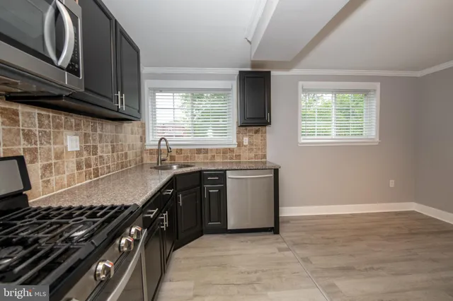 a kitchen with granite countertop a stove and a sink