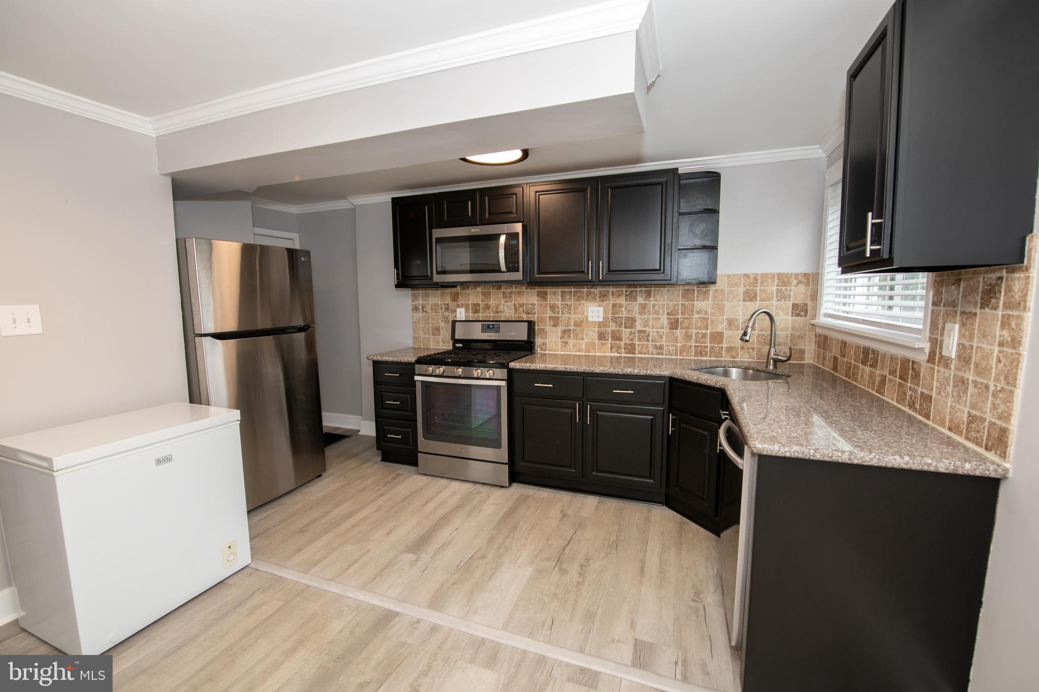 784 Bennington Road Folcroft, PA 19032 - Photo 10 of 36 a kitchen with stainless steel appliances kitchen island granite countertop a refrigerator stove and microwave