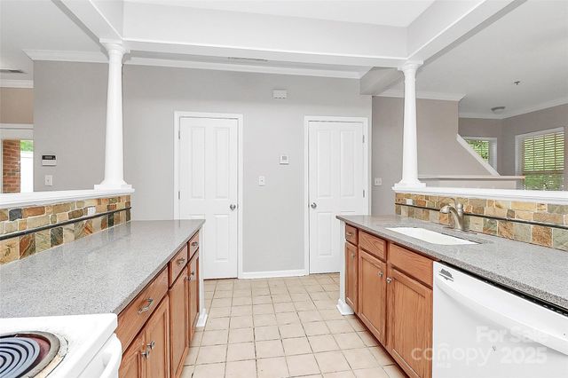 a kitchen with stainless steel appliances granite countertop a sink stove and cabinets