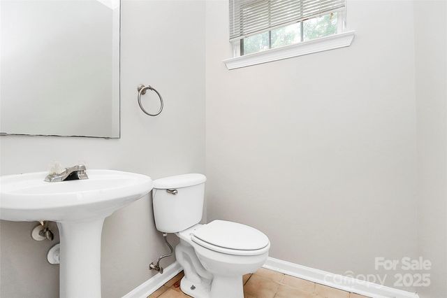 a bathroom with a sink mirror vanity and toilet