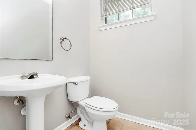 a bathroom with a sink mirror vanity and toilet