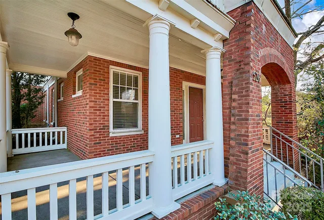a view of a brick house with a porch