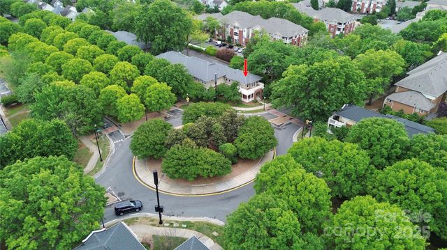 an aerial view of residential house with outdoor space and trees all around
