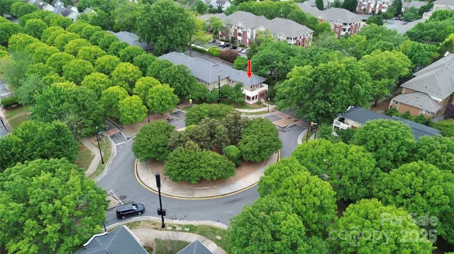 an aerial view of residential house with outdoor space and trees all around
