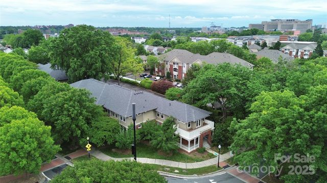 an aerial view of a house with a yard and lake view