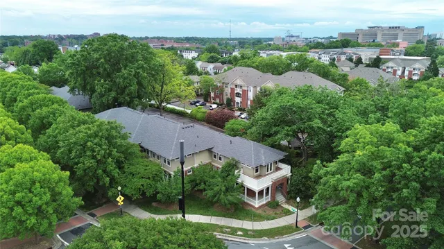 an aerial view of a house with a yard and lake view