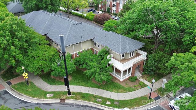 an aerial view of a house with garden space and street view