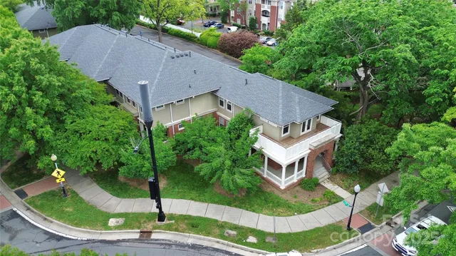 an aerial view of a house with garden space and street view