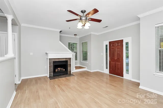 an empty room with ceiling fan and a fireplace