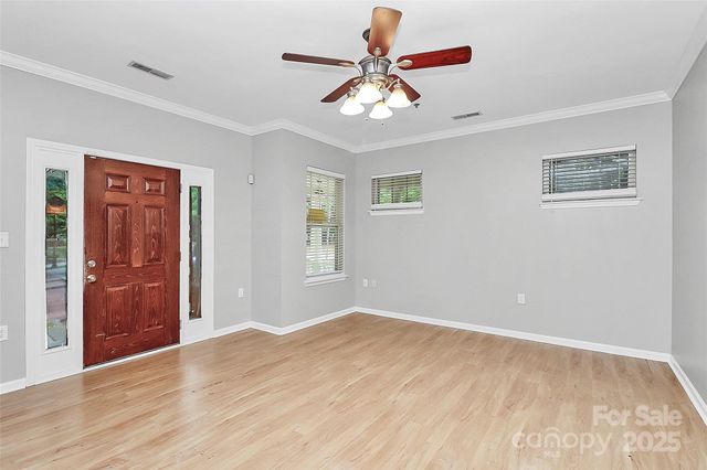 a view of wooden floor and windows in a room