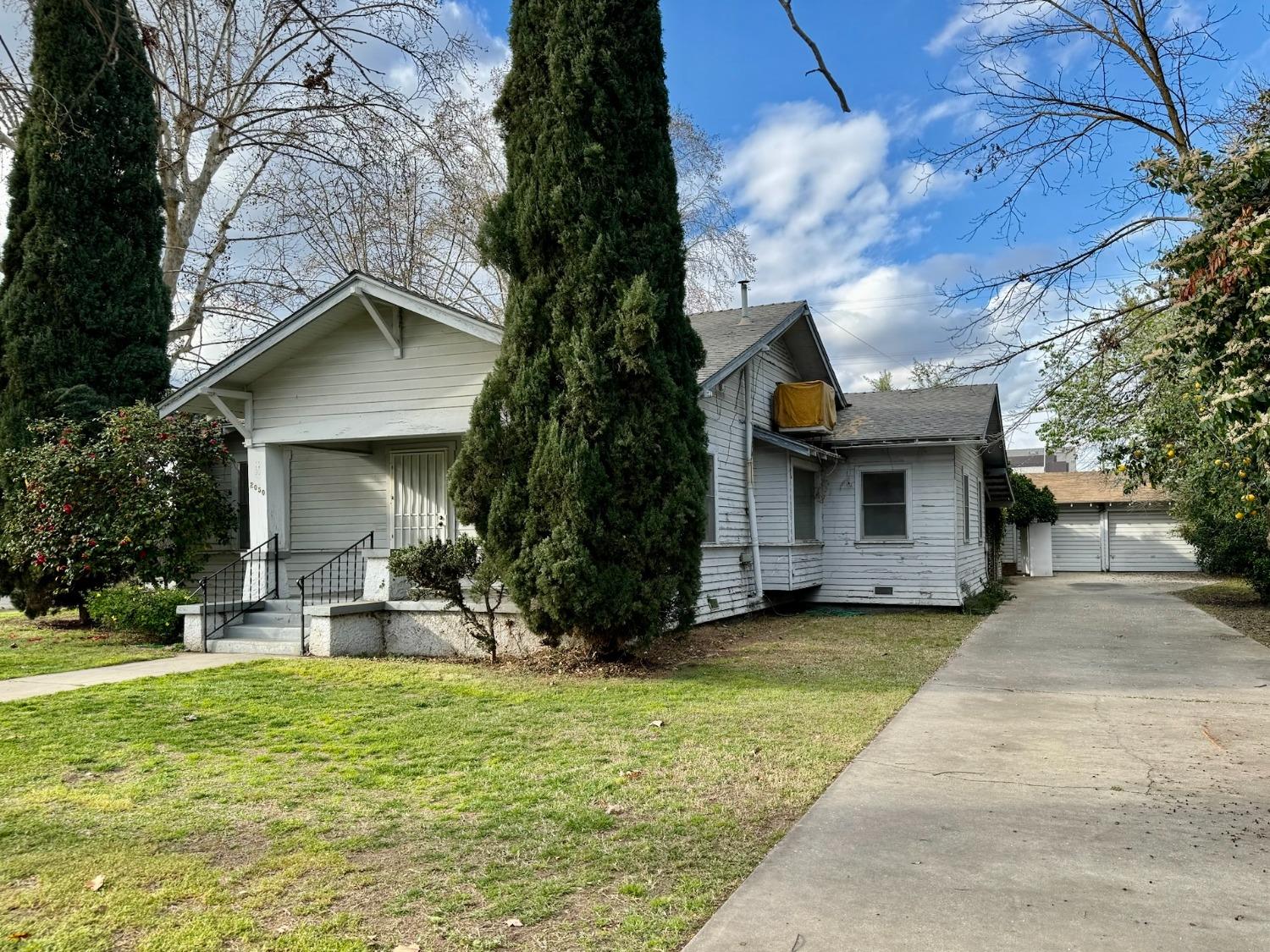 2050 Merced Street Selma, CA 93662 - Photo 2 of 6 a front view of a house with a yard garage and outdoor seating