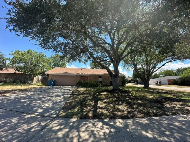a backyard of a house with yard and outdoor seating