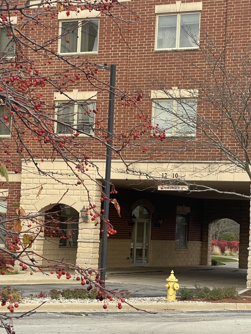 1210 Foxdale Drive, Unit 109 Addison, IL 60101 - Photo 1 of 29 a view of a building with a bench