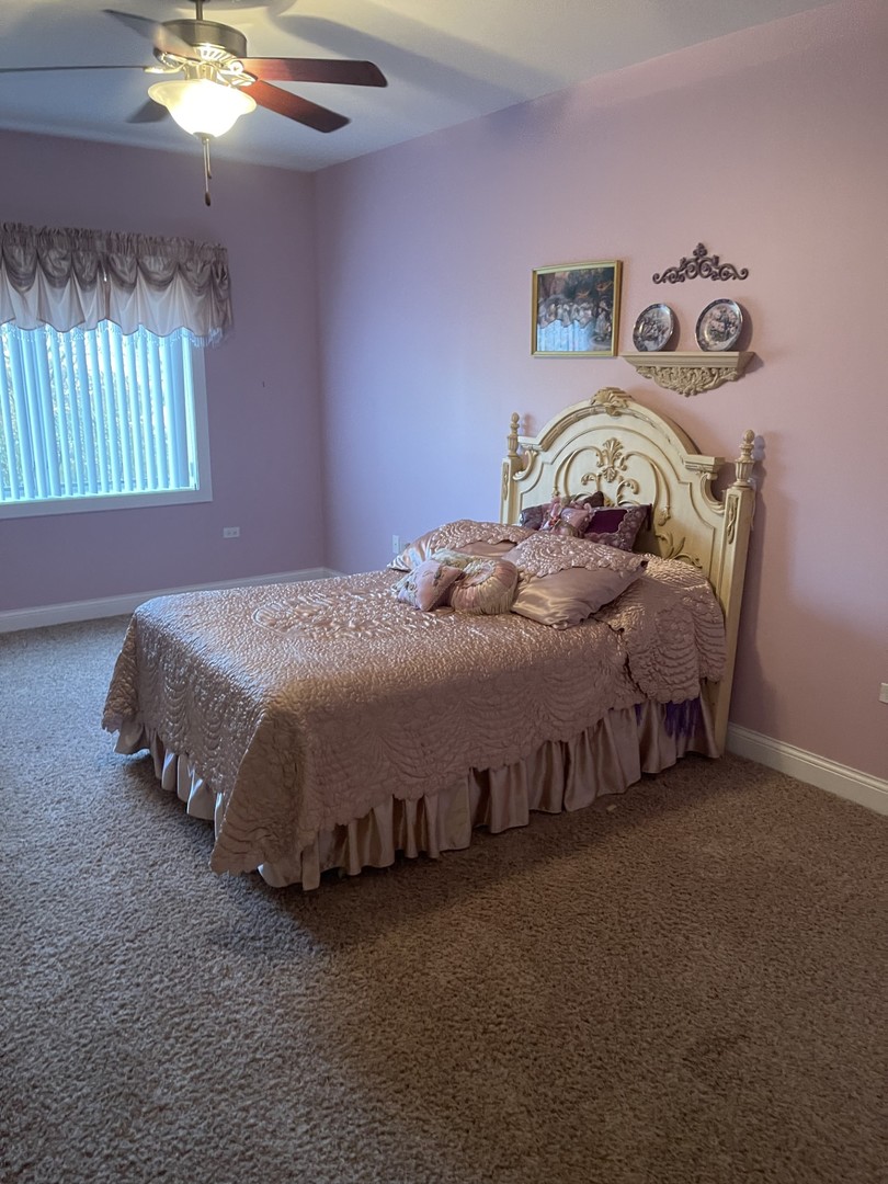 1210 Foxdale Drive, Unit 109 Addison, IL 60101 - Photo 17 of 29 a bedroom with a bed and a chandelier