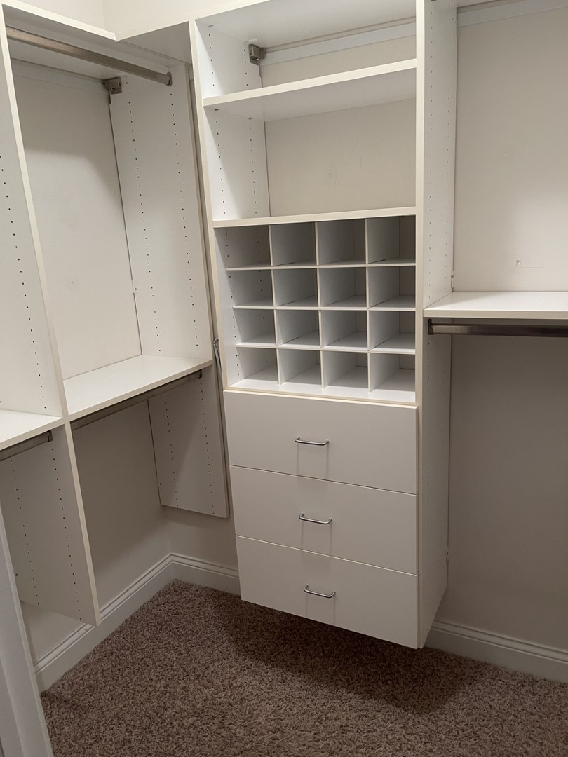 1210 Foxdale Drive, Unit 109 Addison, IL 60101 - Photo 18 of 29 a view of an empty room with wooden floor and cabinet