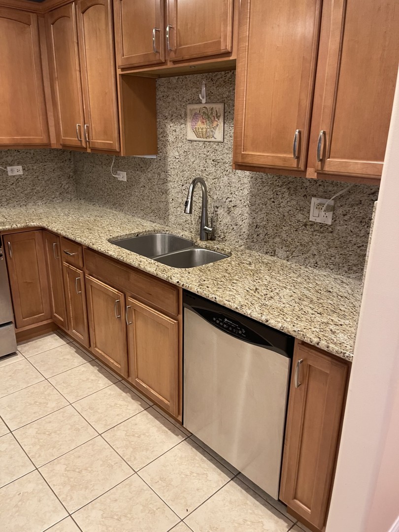 1210 Foxdale Drive, Unit 109 Addison, IL 60101 - Photo 10 of 29 a kitchen with stainless steel appliances granite countertop a sink and cabinets