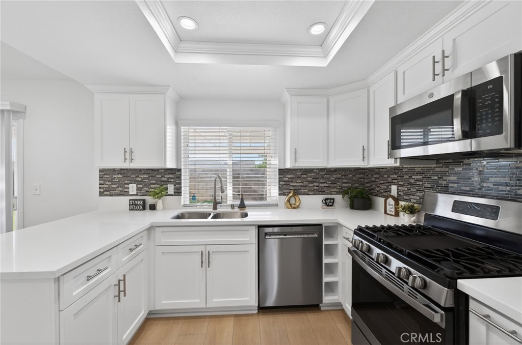831 West Cerritos Street Rialto, CA 92376 - Photo 14 of 47 a kitchen with stainless steel appliances a sink dishwasher stove and microwave