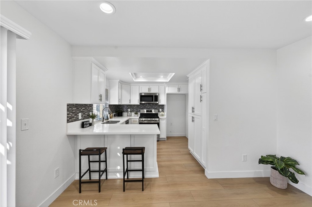831 West Cerritos Street Rialto, CA 92376 - Photo 15 of 47 a kitchen with cabinets and chairs