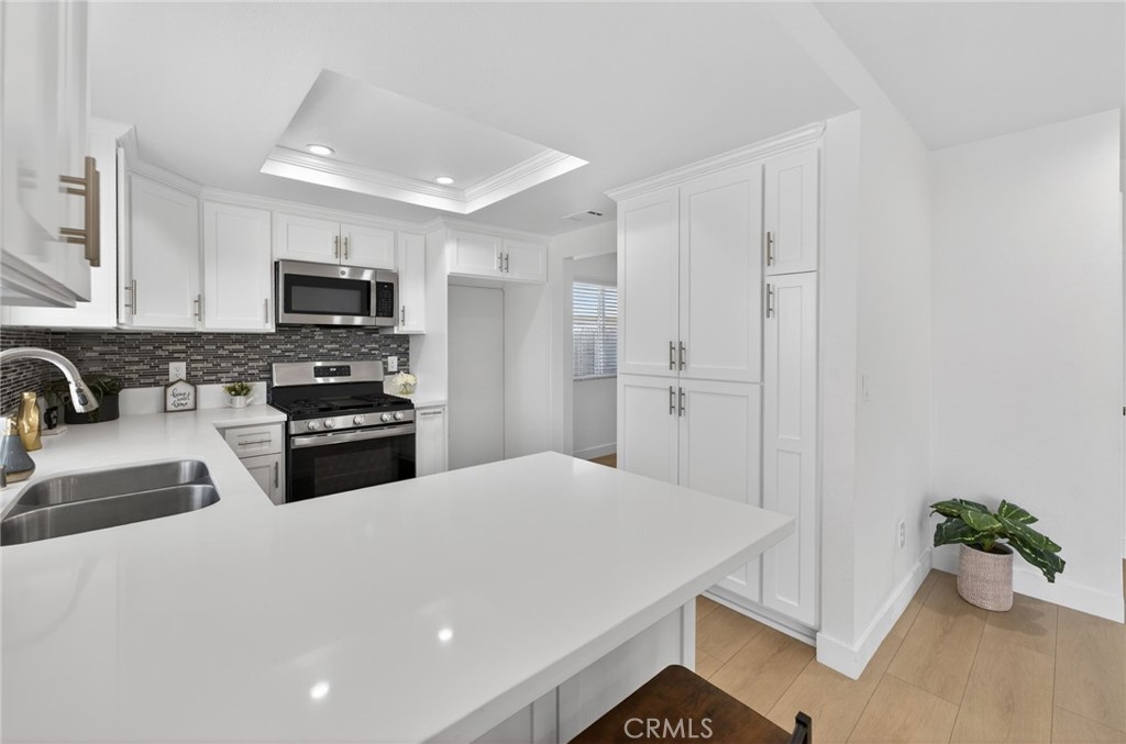 831 West Cerritos Street Rialto, CA 92376 - Photo 16 of 47 a kitchen with kitchen island a refrigerator sink and stove
