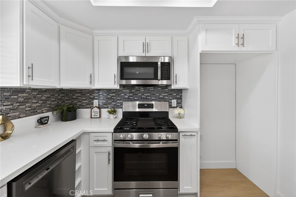 831 West Cerritos Street Rialto, CA 92376 - Photo 17 of 47 a kitchen with cabinets stainless steel appliances and a counter space