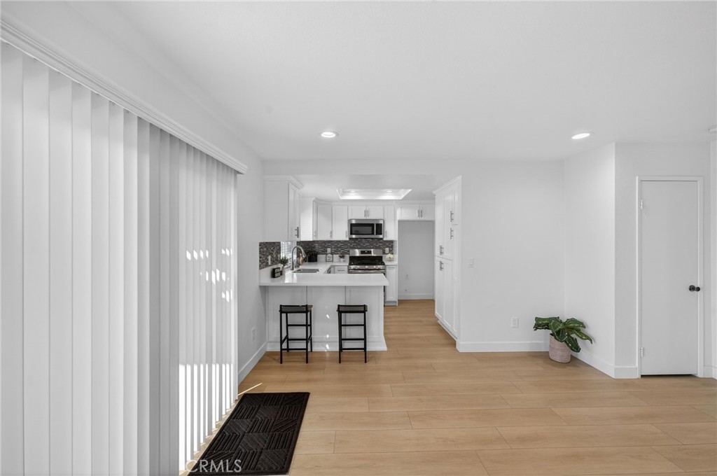 831 West Cerritos Street Rialto, CA 92376 - Photo 22 of 47 a view of kitchen with kitchen island a sink wooden floor and refrigerator