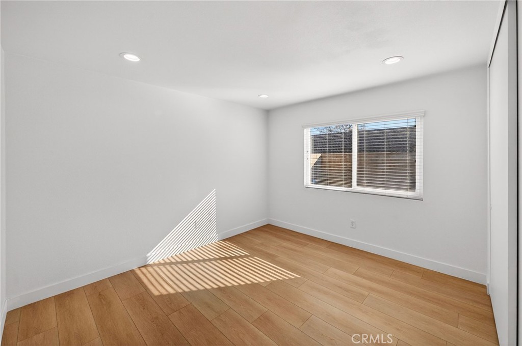 831 West Cerritos Street Rialto, CA 92376 - Photo 26 of 47 a view of an empty room with wooden floor and a window