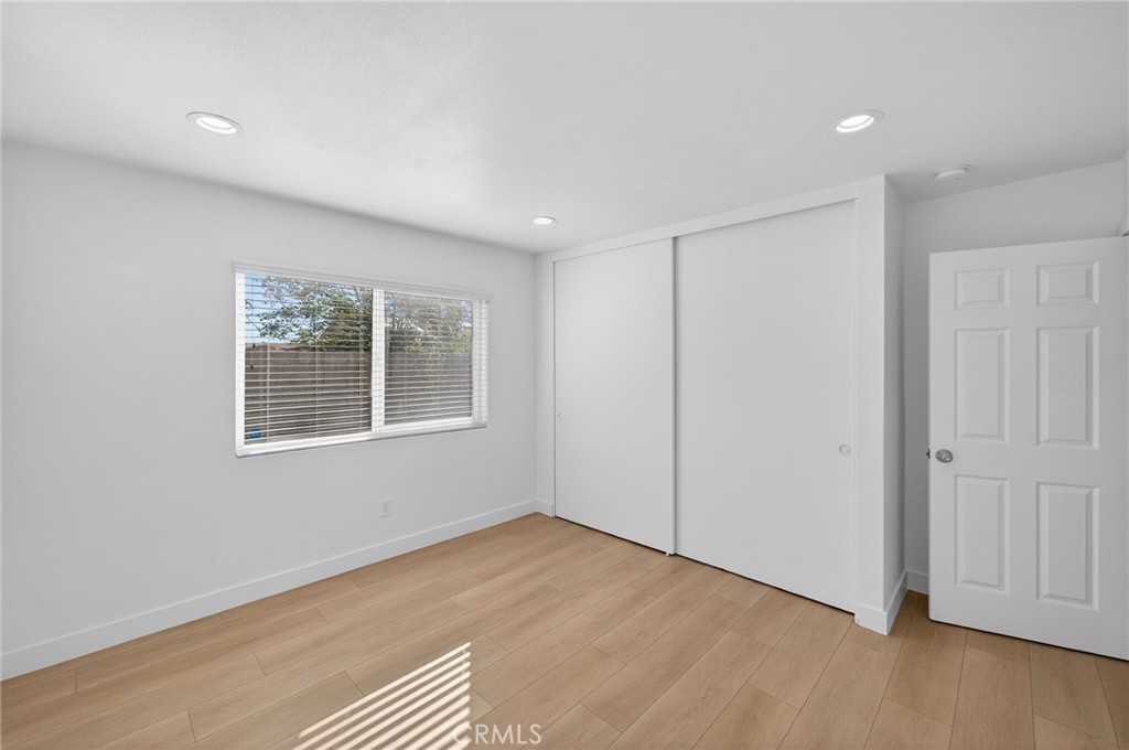 831 West Cerritos Street Rialto, CA 92376 - Photo 27 of 47 a view of an empty room with wooden floor and a window