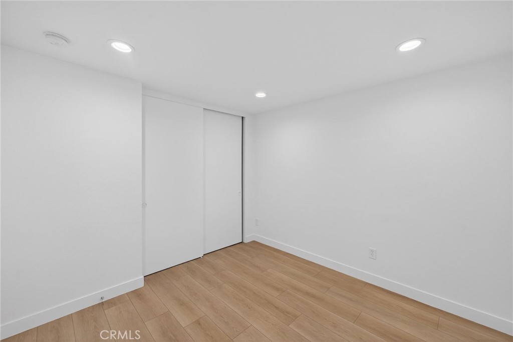 831 West Cerritos Street Rialto, CA 92376 - Photo 29 of 47 a view of an empty room with wooden floor and a window