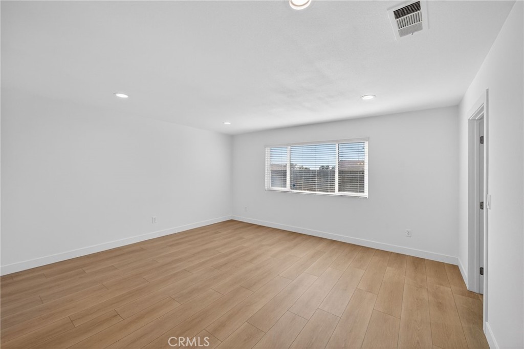 831 West Cerritos Street Rialto, CA 92376 - Photo 30 of 47 an empty room with wooden floor and windows