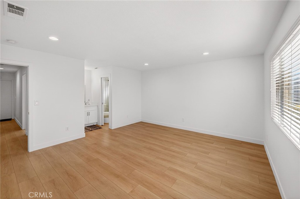831 West Cerritos Street Rialto, CA 92376 - Photo 31 of 47 a view of an empty room with wooden floor and a window