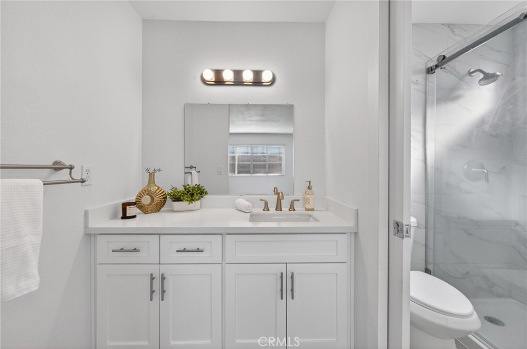 831 West Cerritos Street Rialto, CA 92376 - Photo 35 of 47 a bathroom with a sink a toilet and shower