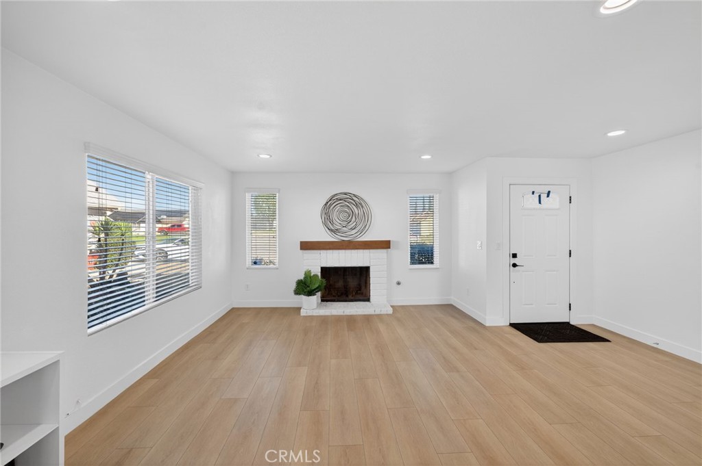 831 West Cerritos Street Rialto, CA 92376 - Photo 9 of 47 a view of an empty room with a window and fireplace