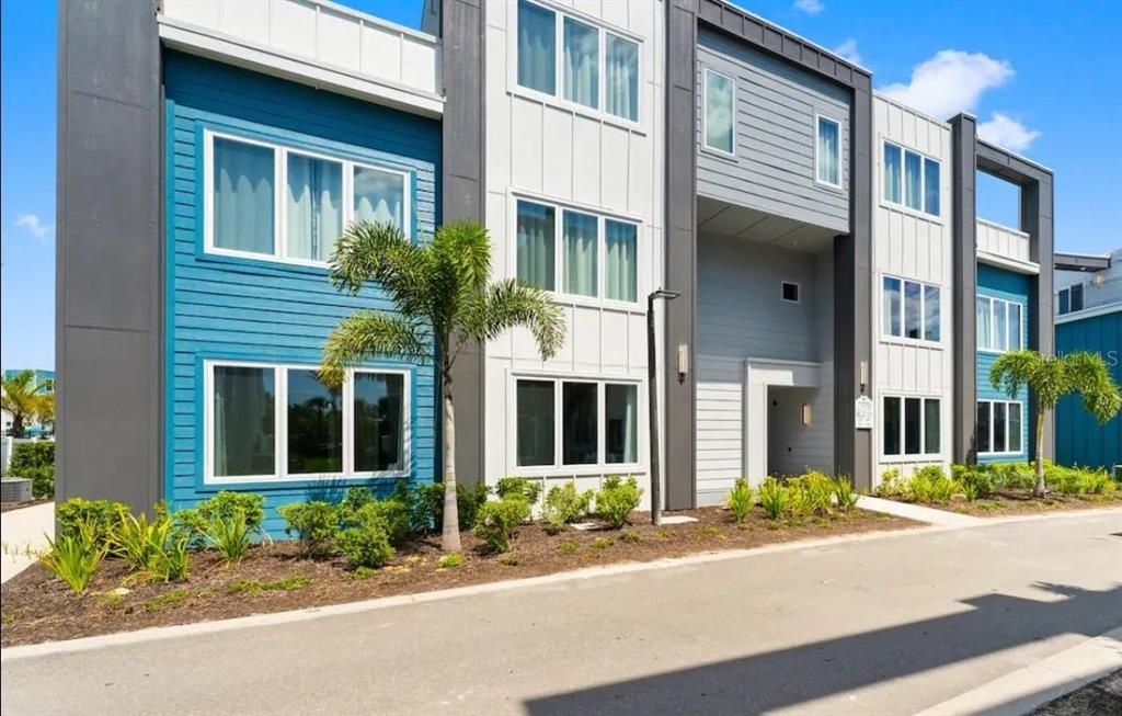 front view of a brick house with a yard