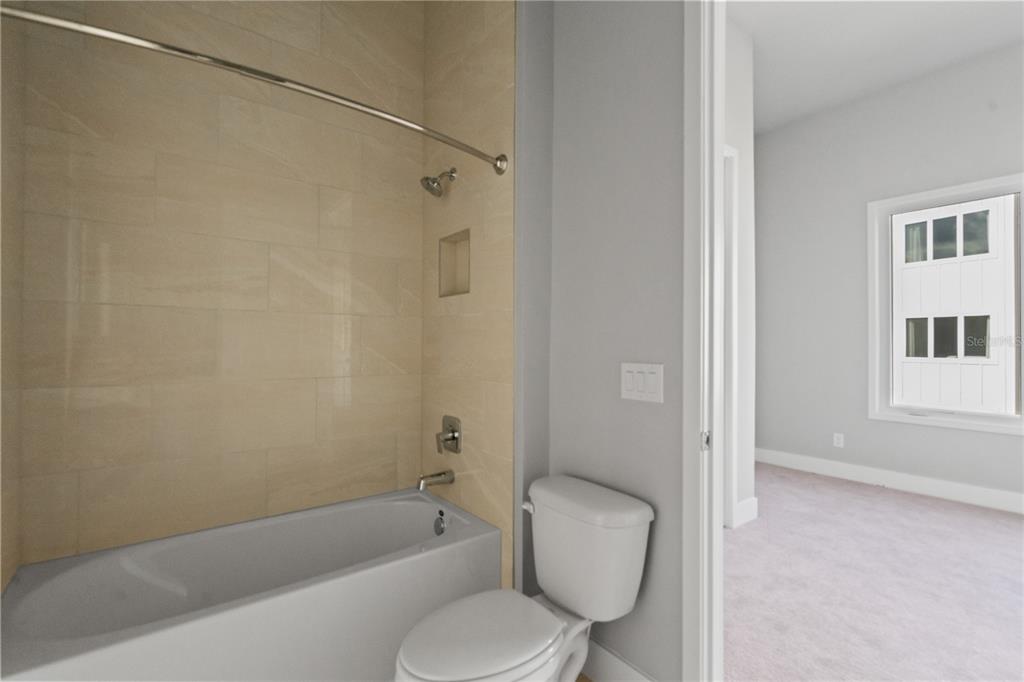 7770 Sandy Ridge Drive, Unit 239 Reunion, FL 34747 - Photo 12 of 49 a bathroom with a toilet and a bathtub