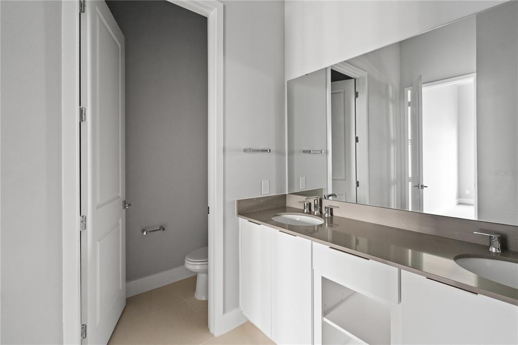 7770 Sandy Ridge Drive, Unit 239 Reunion, FL 34747 - Photo 14 of 49 a bathroom with a granite countertop sink and a mirror