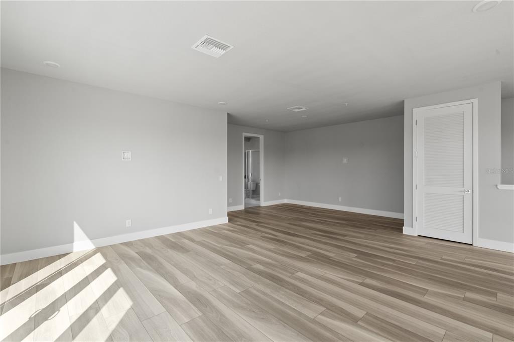 7770 Sandy Ridge Drive, Unit 239 Reunion, FL 34747 - Photo 18 of 49 a view of empty room with wooden floor