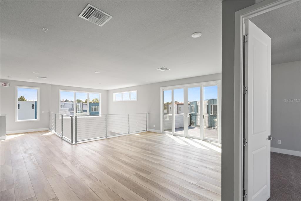 7770 Sandy Ridge Drive, Unit 239 Reunion, FL 34747 - Photo 20 of 49 a view of a kitchen with wooden floor and a fireplace