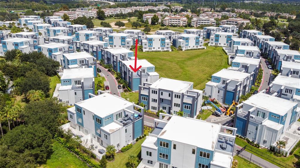 7770 Sandy Ridge Drive, Unit 239 Reunion, FL 34747 - Photo 29 of 49 an aerial view of a city with lots of residential buildings ocean and mountain view in back