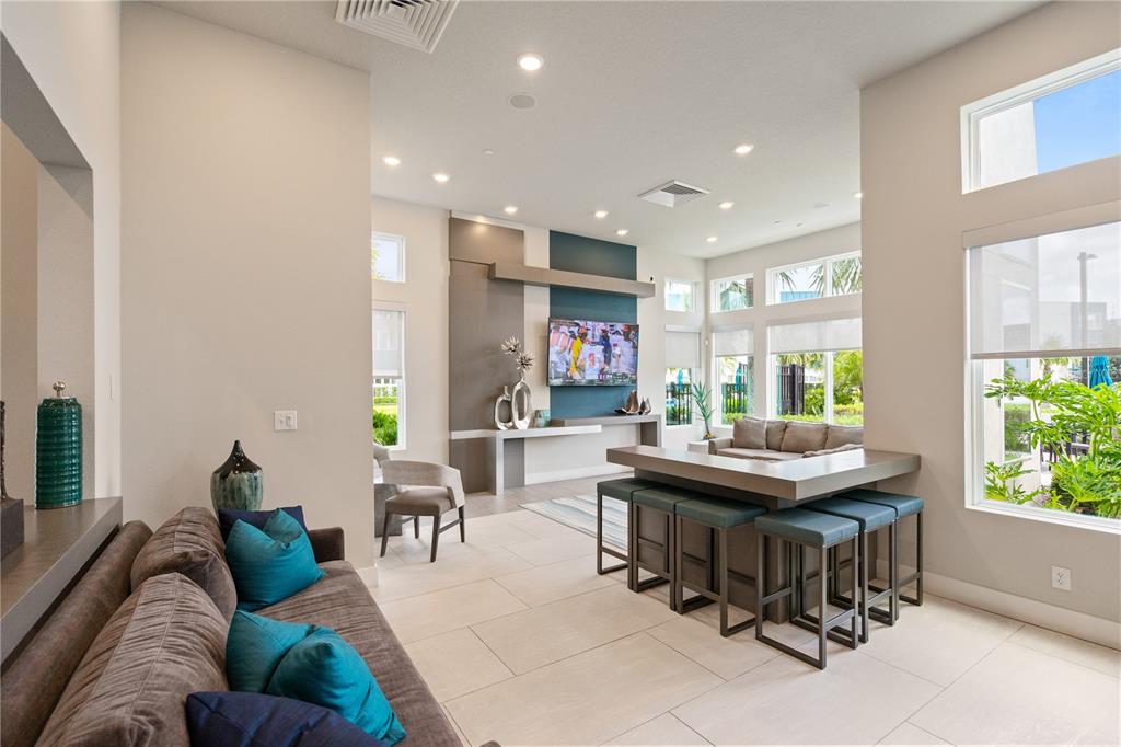 7770 Sandy Ridge Drive, Unit 239 Reunion, FL 34747 - Photo 42 of 49 a living room with furniture and a large window