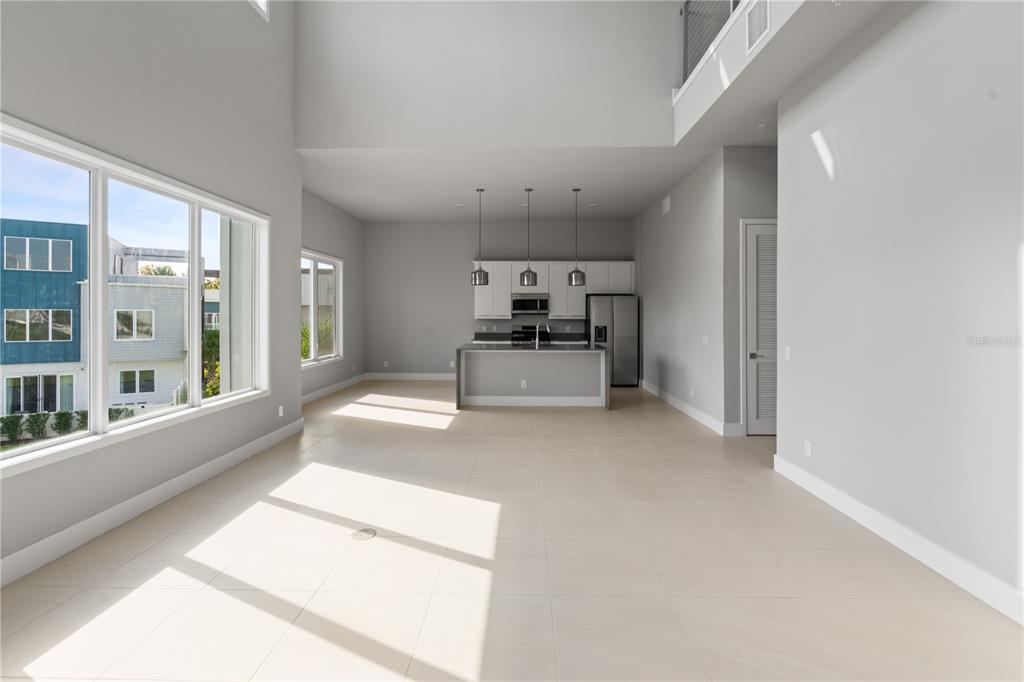 7770 Sandy Ridge Drive, Unit 239 Reunion, FL 34747 - Photo 6 of 49 a large white kitchen with granite countertop a large window and stainless steel appliances