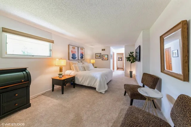 a bathroom with a tub a sink and a large mirror